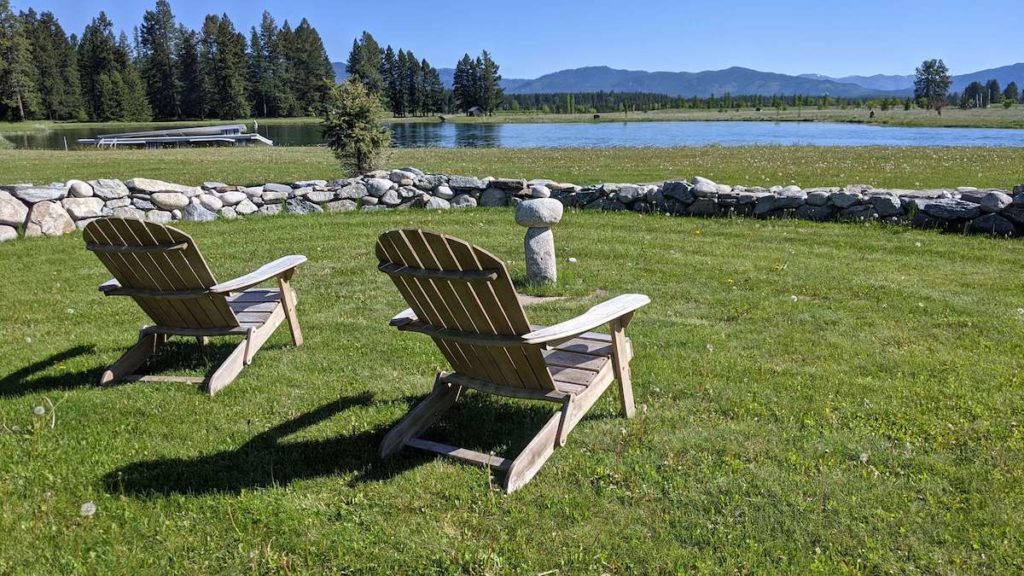 two Adirondack chairs with mountain view