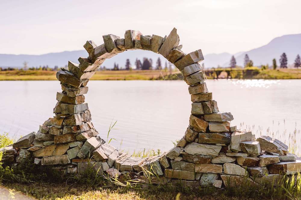 circular stone arch overlooking pond in Montana