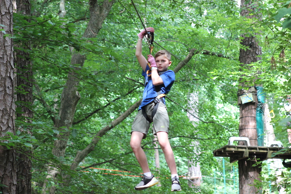 boy ziplining at Treetop Quest