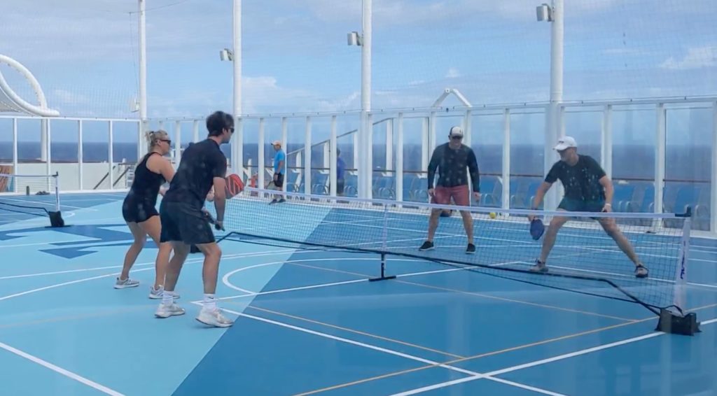 people playing pickleball on sports deck