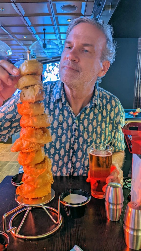 chris schroder with stack of onion rings
