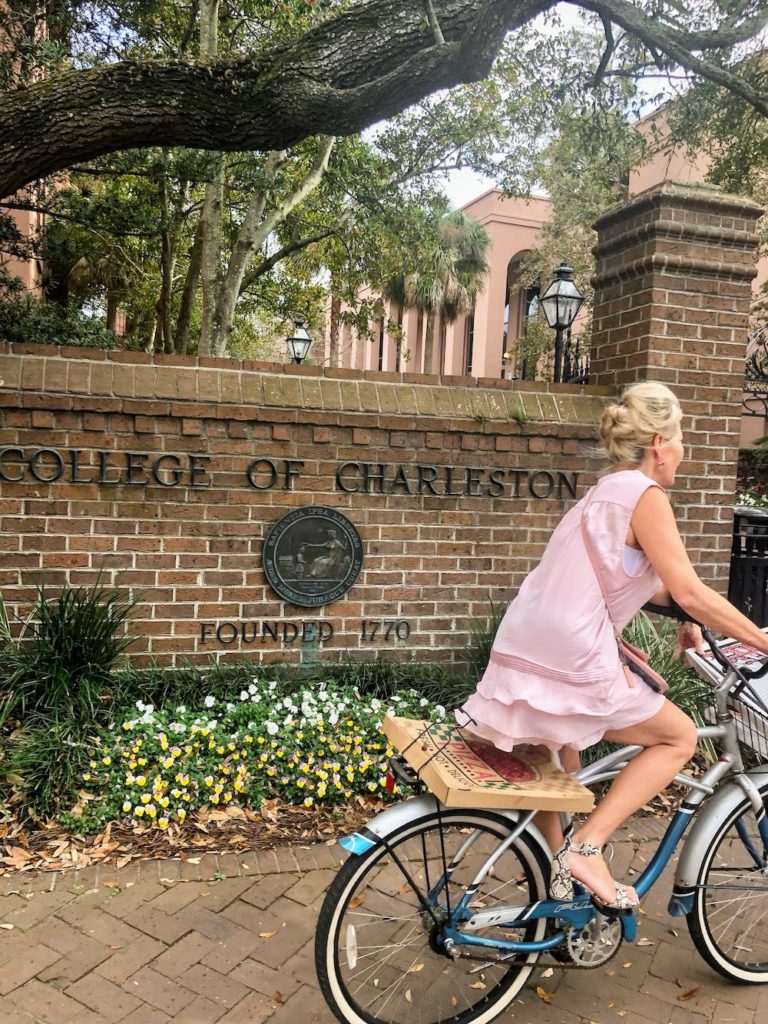 woman on bicycle in front of college of charleston