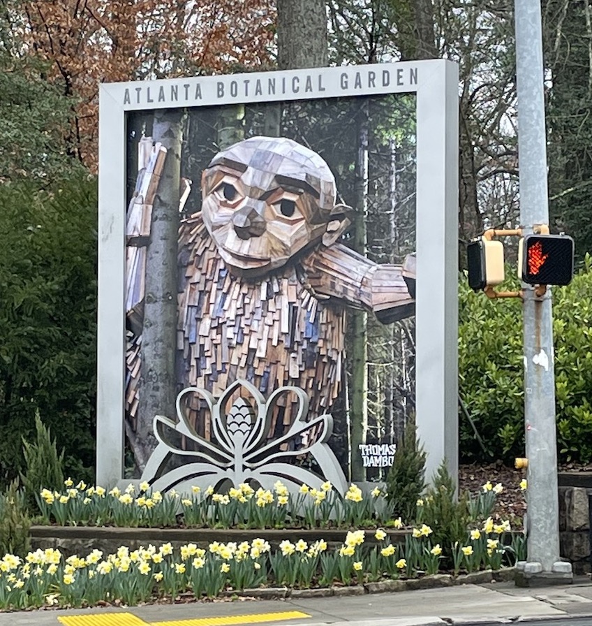 entrance to the Atlanta Botanical garden with sign for Troll exhibit