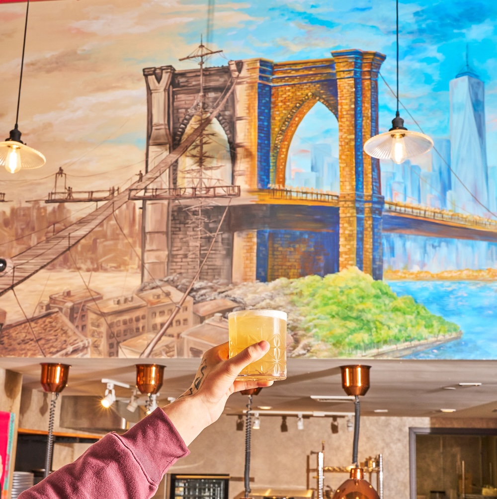 mural of the brooklyn bridge at Evolution in 42 hotel